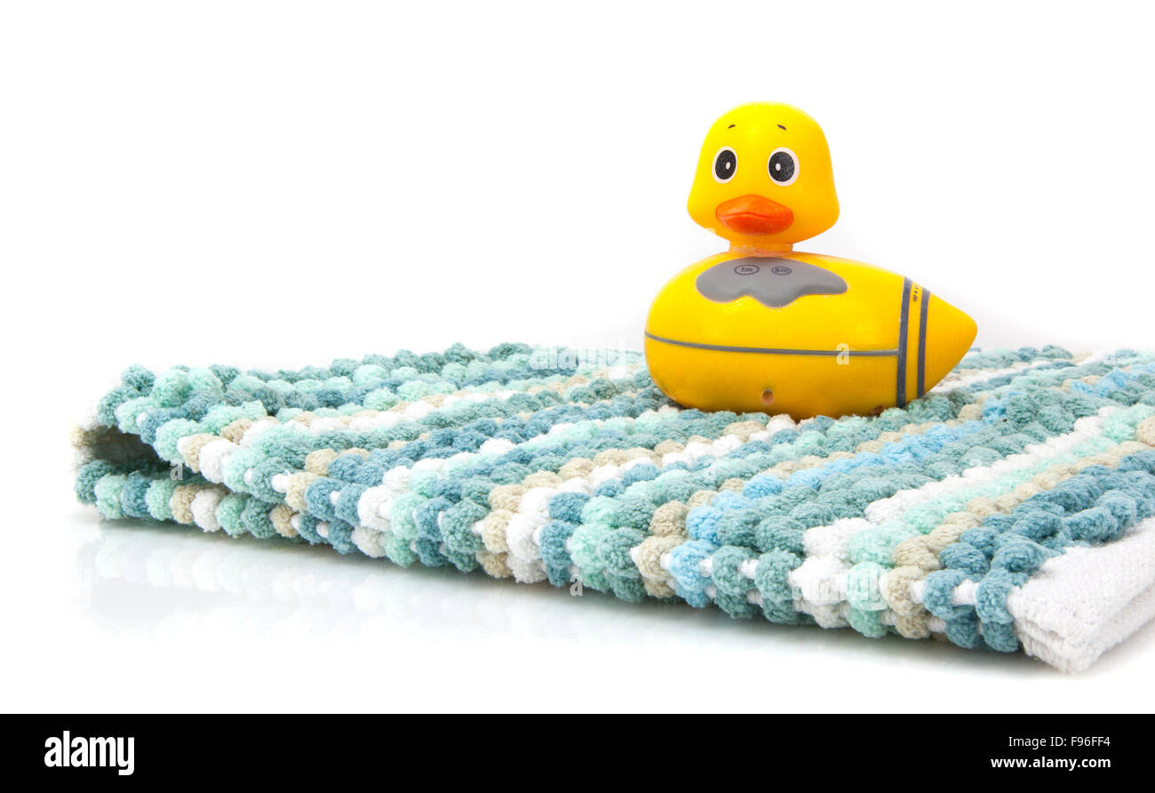 A Yellow Duck And Bathmat On A White Background Stock Photo