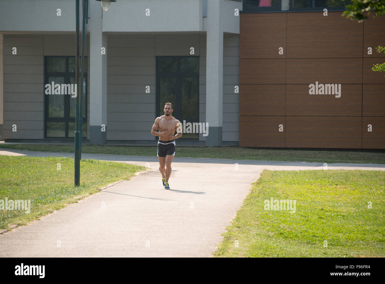Young Bodybuilder Running In Park Area Training And Exercising For