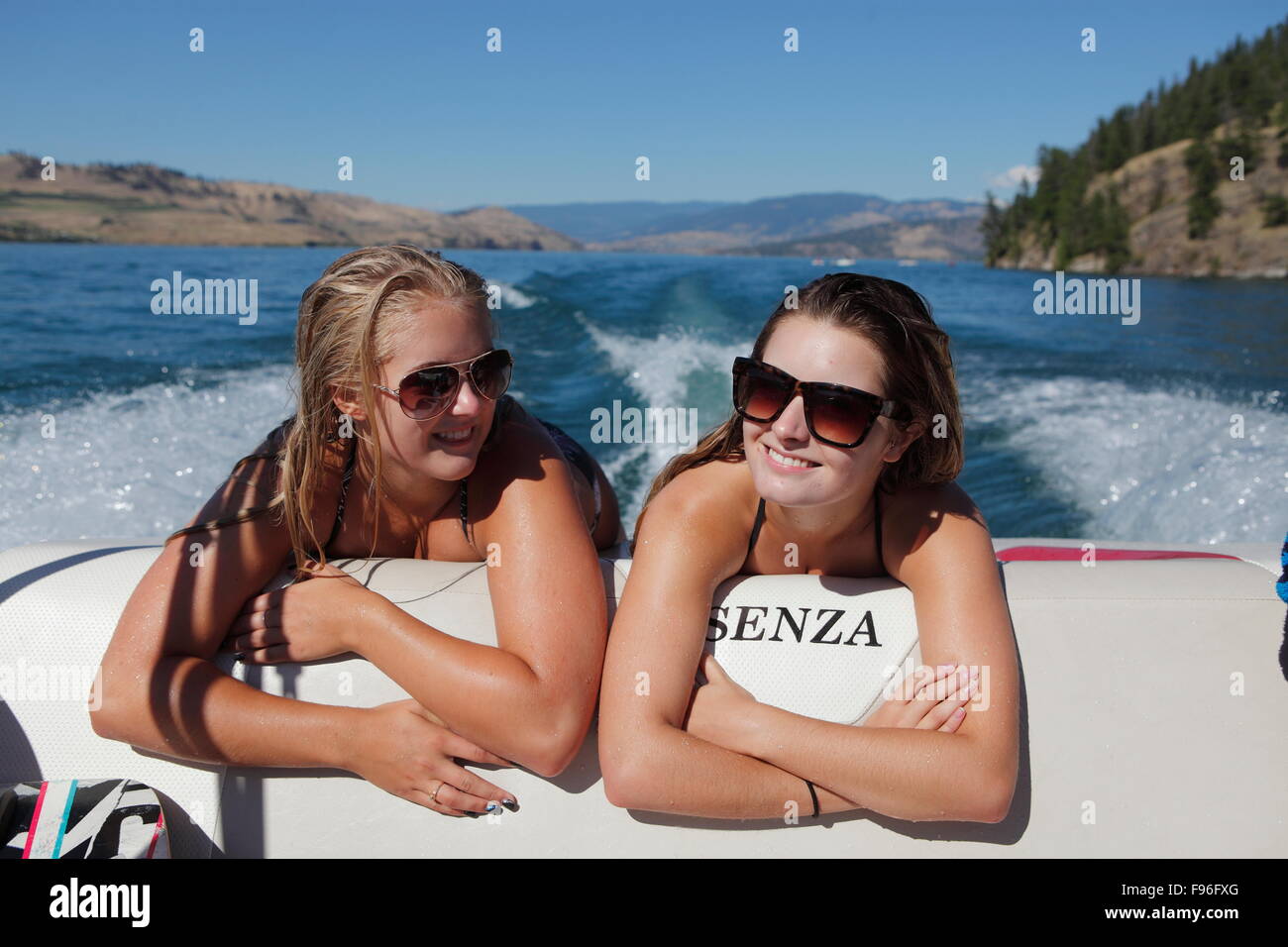 Boating, Young Women, Kalamlka Lake, Vernon British Columbia, Sun Glasses Stock Photo
