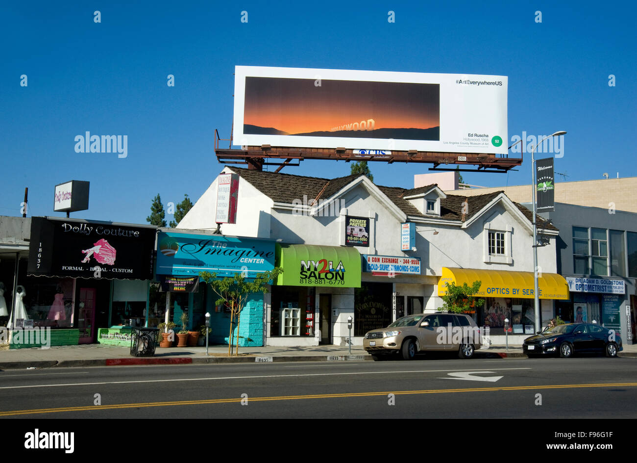 An Edward Ruscha fine art painting is reproduced on a billboard in Los