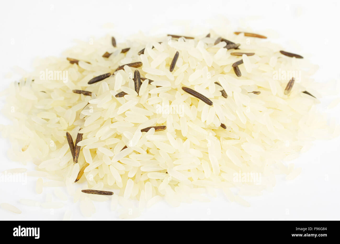 Closeup of long rice mixed with wild rice isolated on white background ...