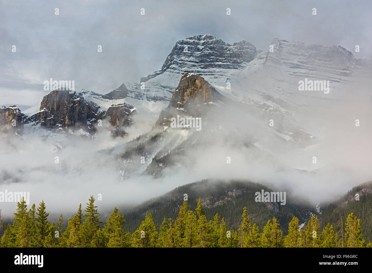 Snow covered and fog shrouded Mount Rundle Mountains, Banff National Park, Alberta, Canada Stock Photo