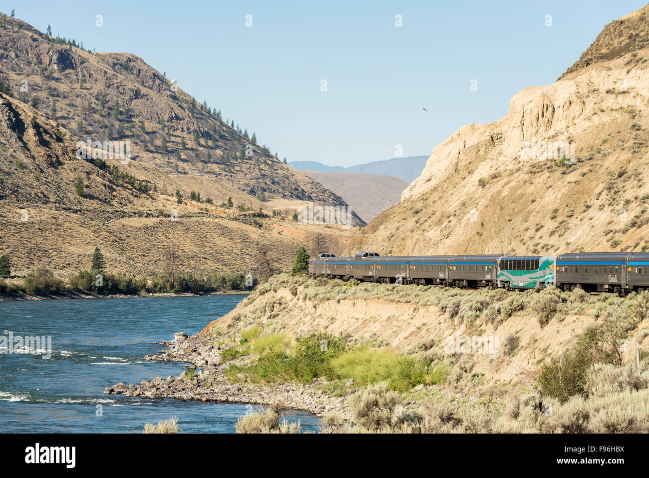 Passenger train along the Thompson River near Ashcroft in British ...