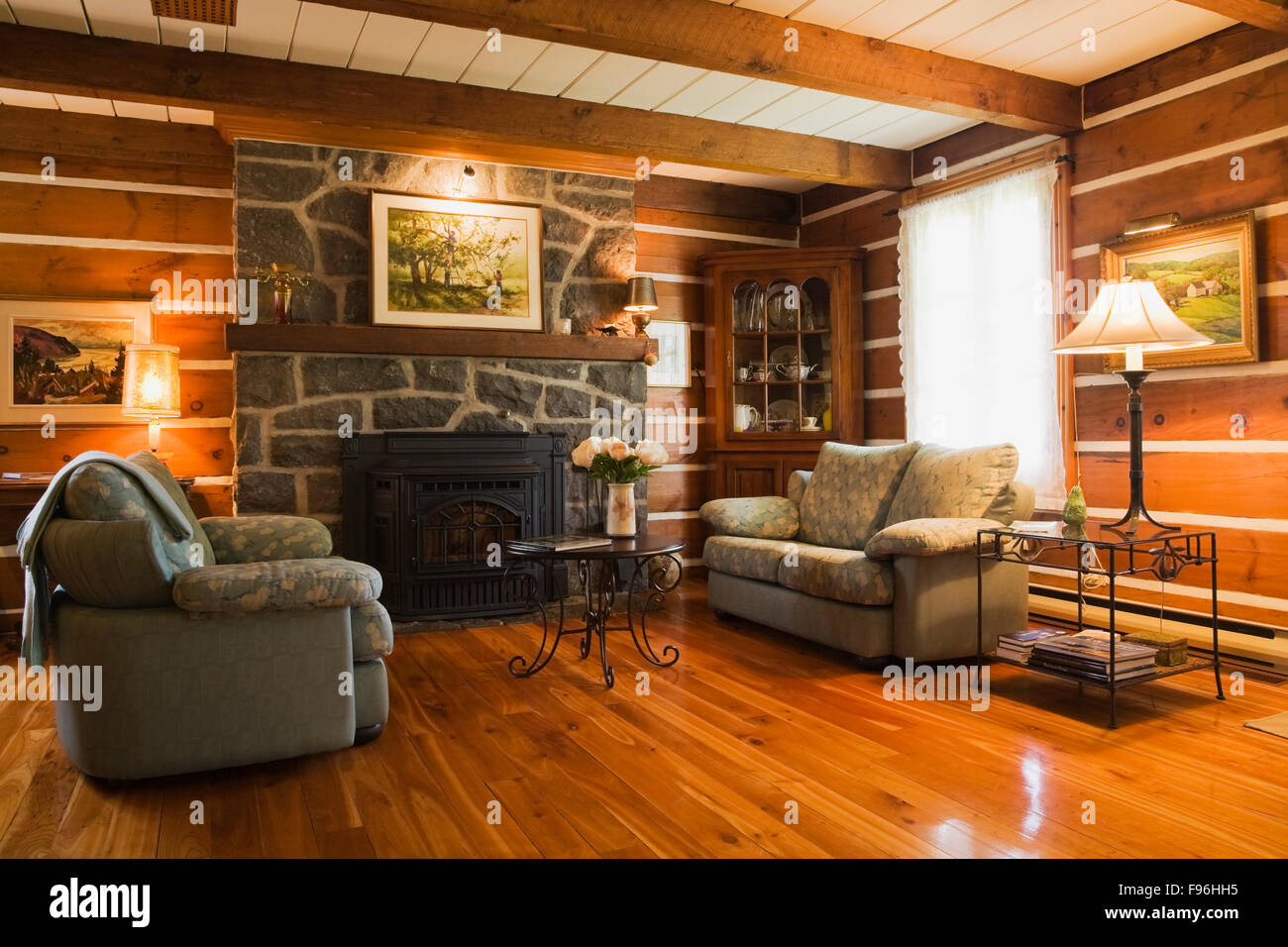 Sofas And Stone Fireplace In The Living Room Inside A Stacked Log