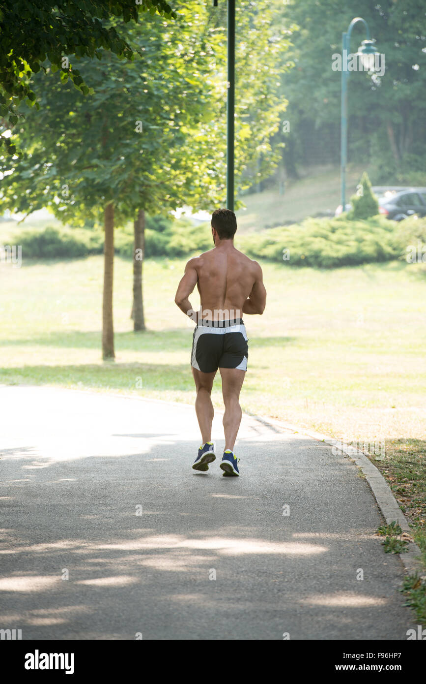 Young Bodybuilder Running In Park Area Training And Exercising For