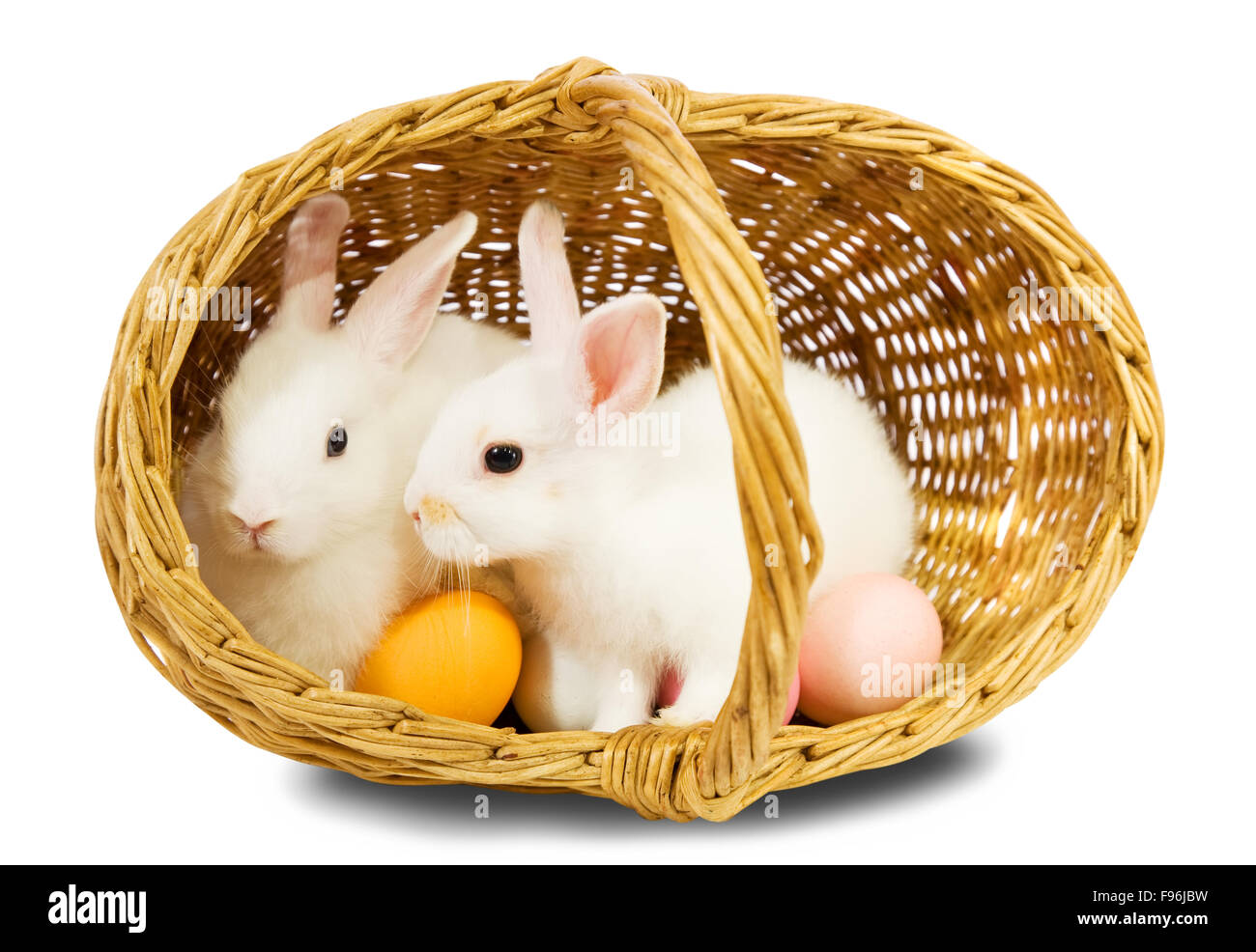 Two white rabbits in basket with eggs. Isolated on white background ...