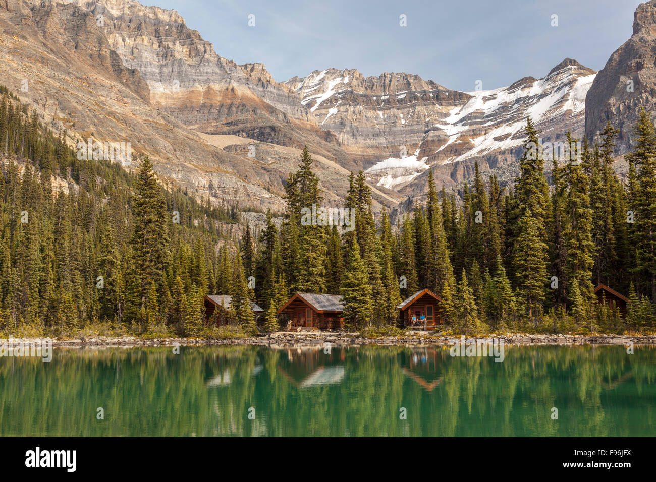 A couple relax on their cabin porch at Lake O'Hara, Yoho National Park, British Columbia, Canada. No Model Release Stock Photo