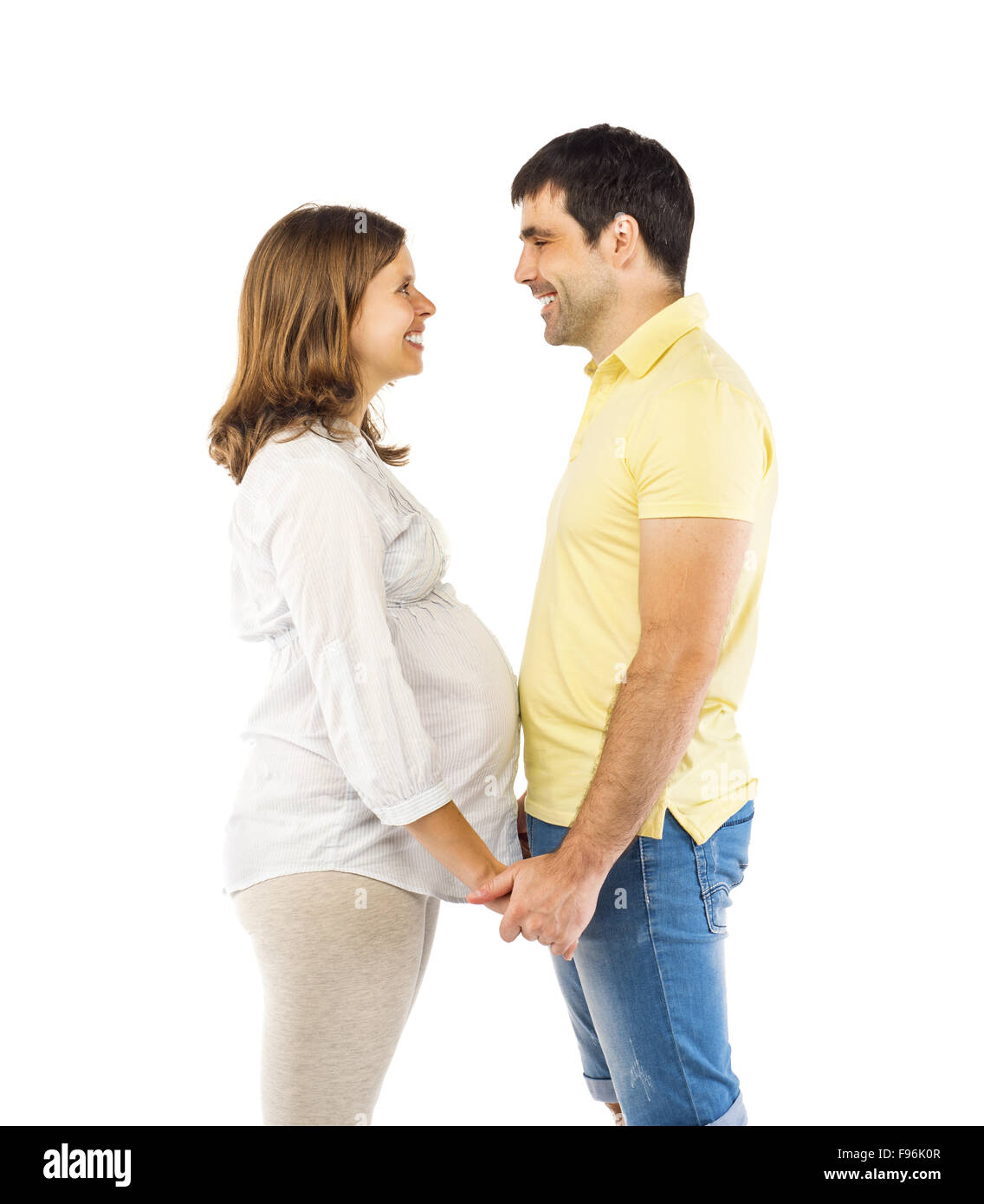 Beautiful young happy smiling pregnant couple, isolated on white background Stock Photo