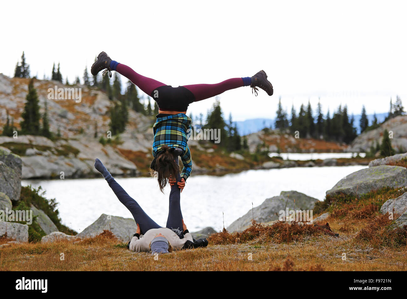 Two friends doing acro yoga, Kokanee Glacier Park, British Columbia, Canada Stock Photo