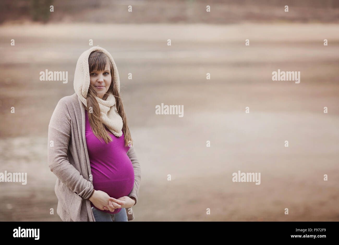 A beautiful outdoor pregnant woman portrait in autumn nature Stock Photo