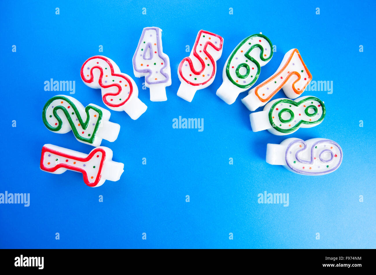Birthday candles against colourful background Stock Photo - Alamy