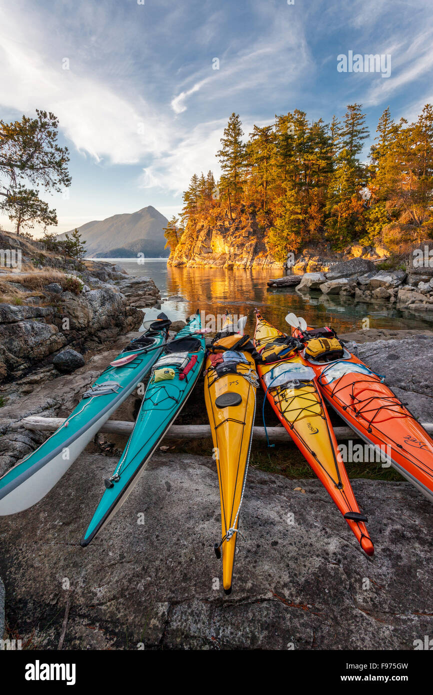 Kayaks rest just above the high tide mark on West Curme Island in Desolation Sound Marine Park. British Columbia, Canada. Stock Photo