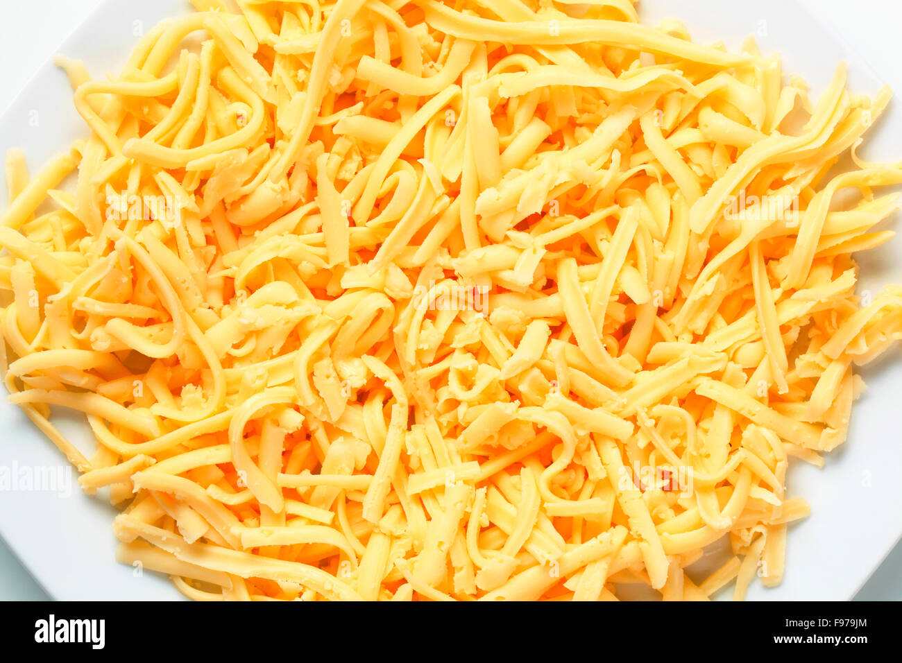 Plate of grated yellow cheese Stock Photo Alamy