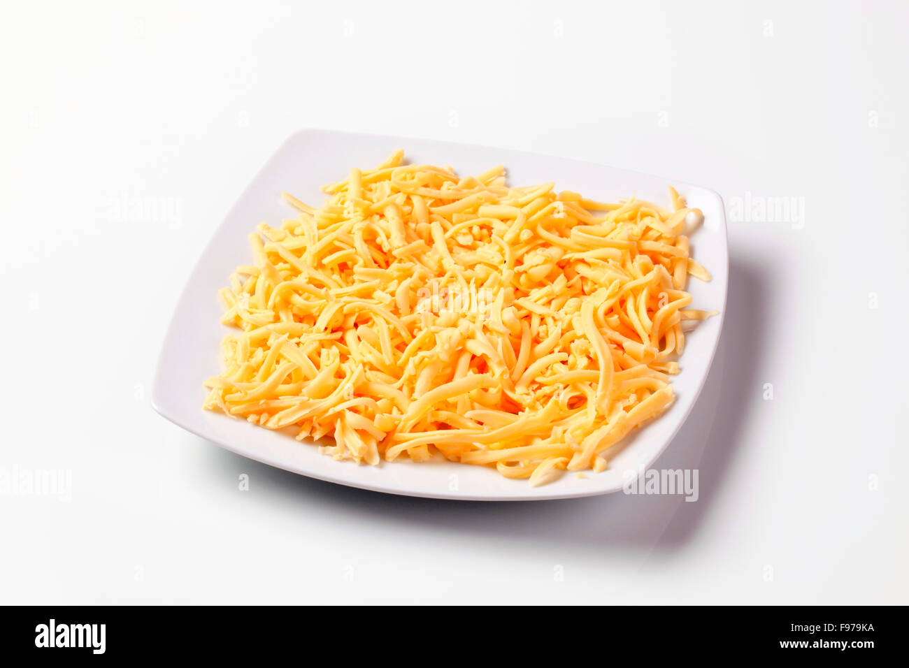 Plate of grated yellow cheese Stock Photo Alamy