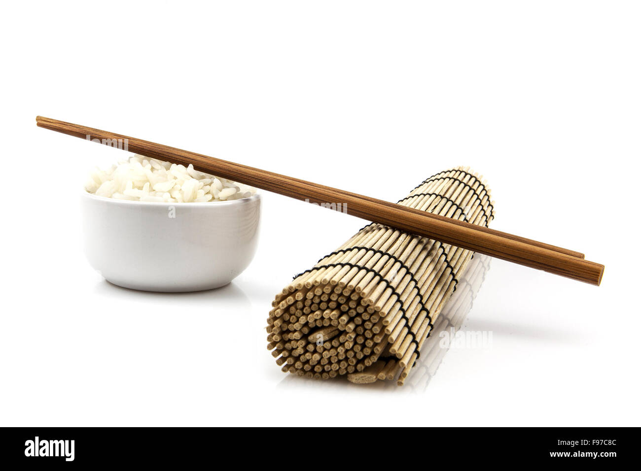Bowl of rice and chopsticks on bamboo mat Stock Photo