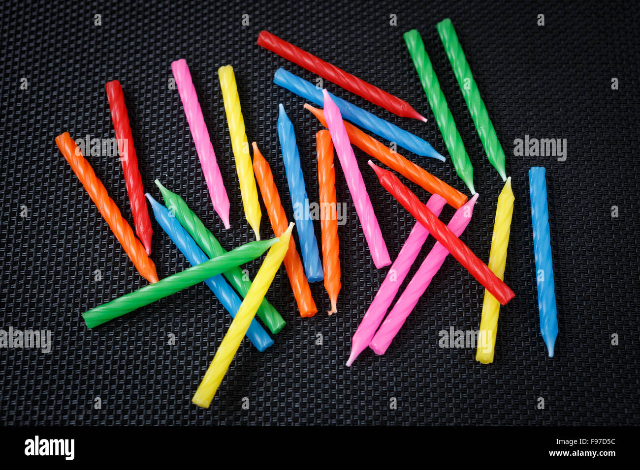 Colorful cake candles on a black background Stock Photo - Alamy