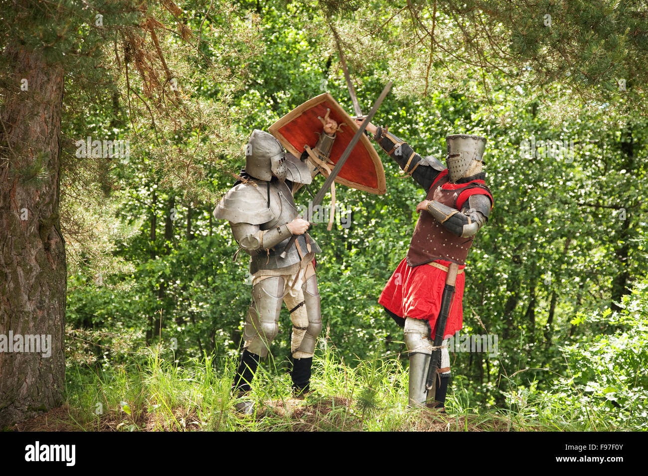 Two knights in armor fights in forest Stock Photo Alamy