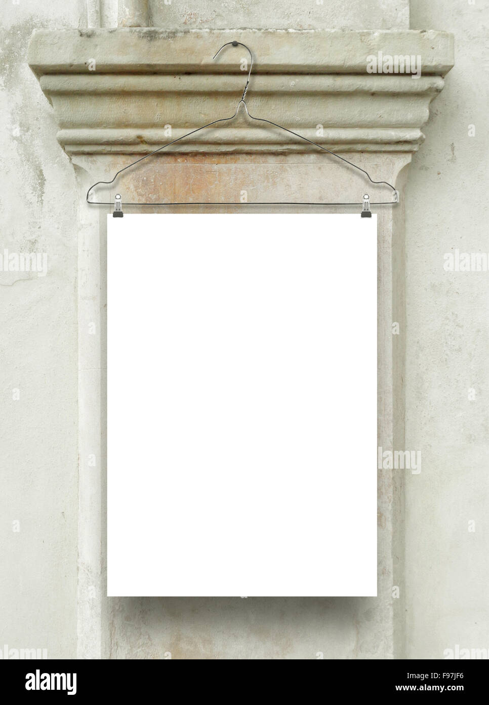 One vertical sheet frame with clothes hanger on ancient stone capital background Stock Photo