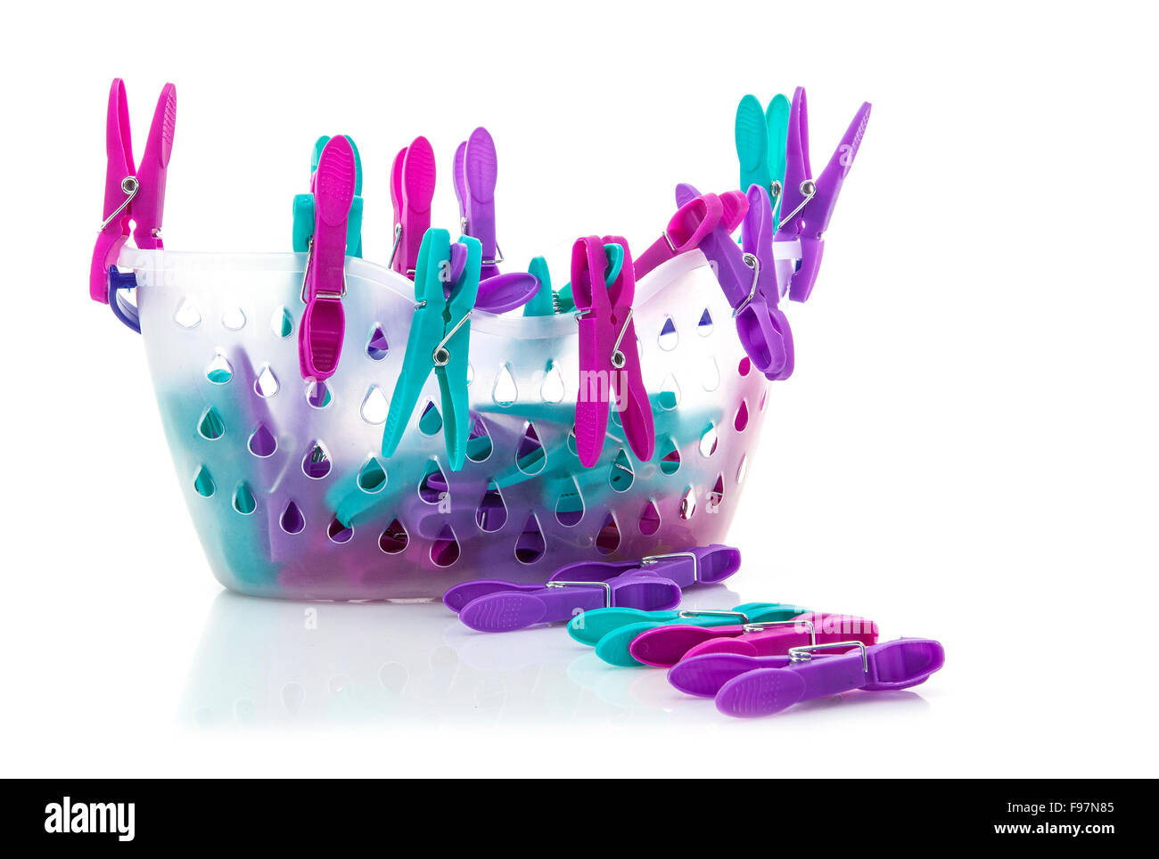 Colorful basket of pegs on white background Stock Photo