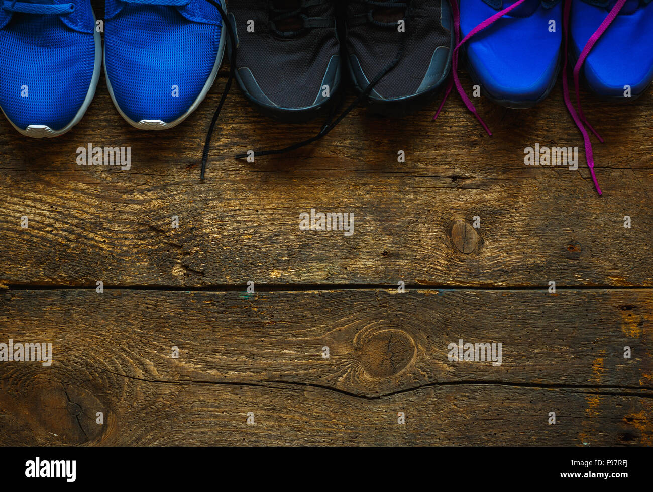 Sport, fitness, shoes, footwear concept - close up of sneakers on wooden background Stock Photo