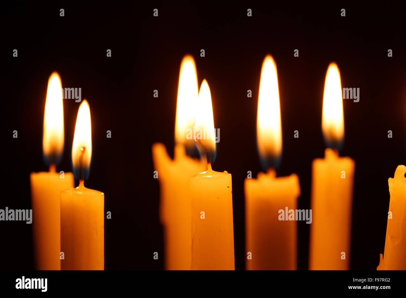 Many burning candles on black background Stock Photo - Alamy