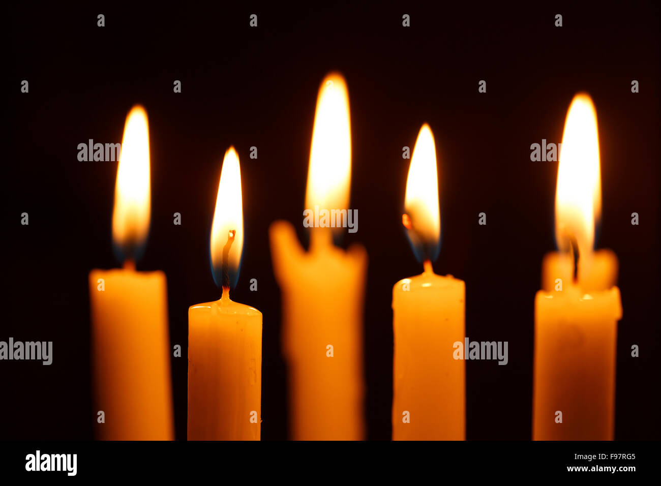 Many burning candles on black background Stock Photo - Alamy