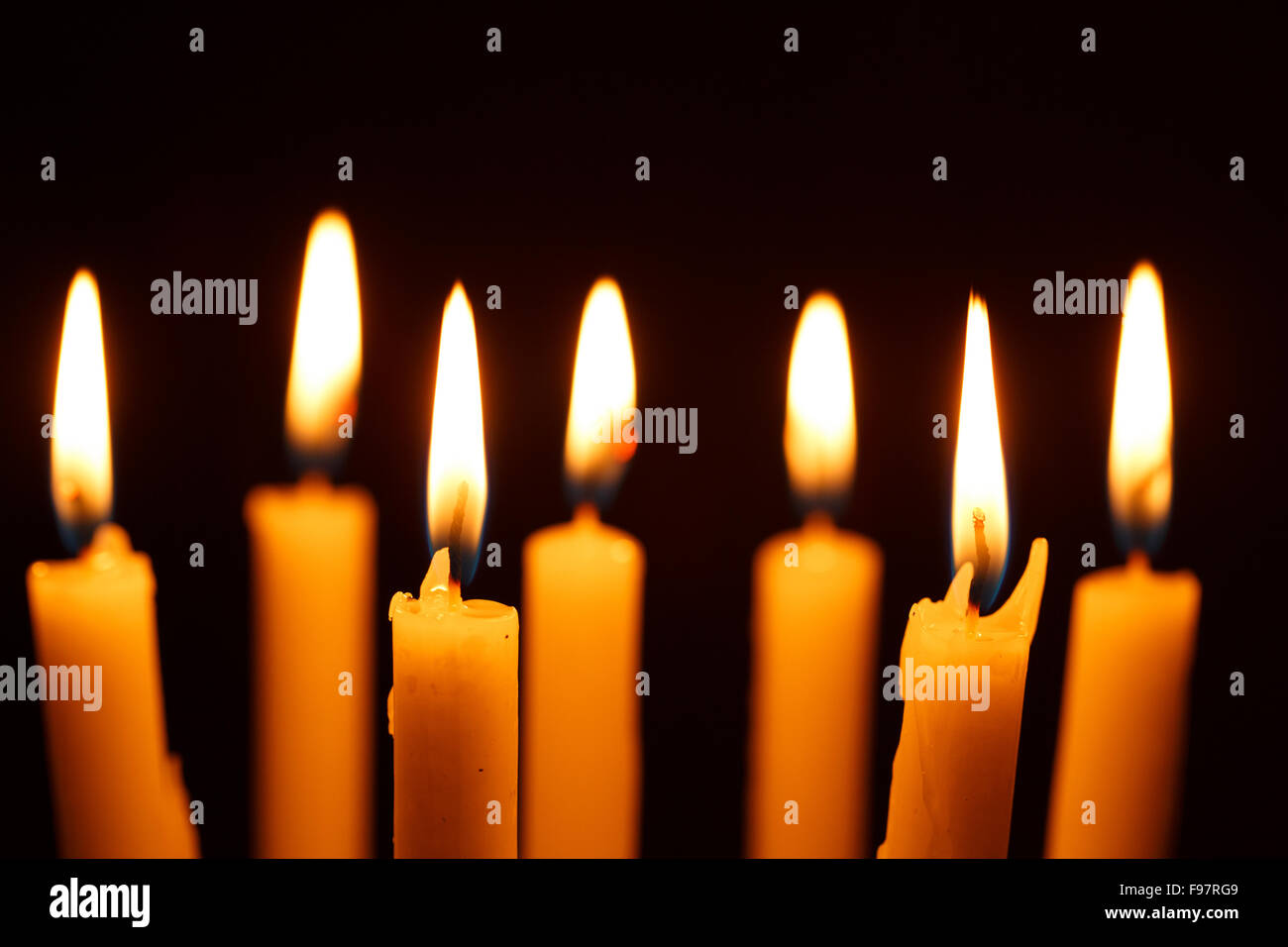 Many burning candles on black background Stock Photo - Alamy