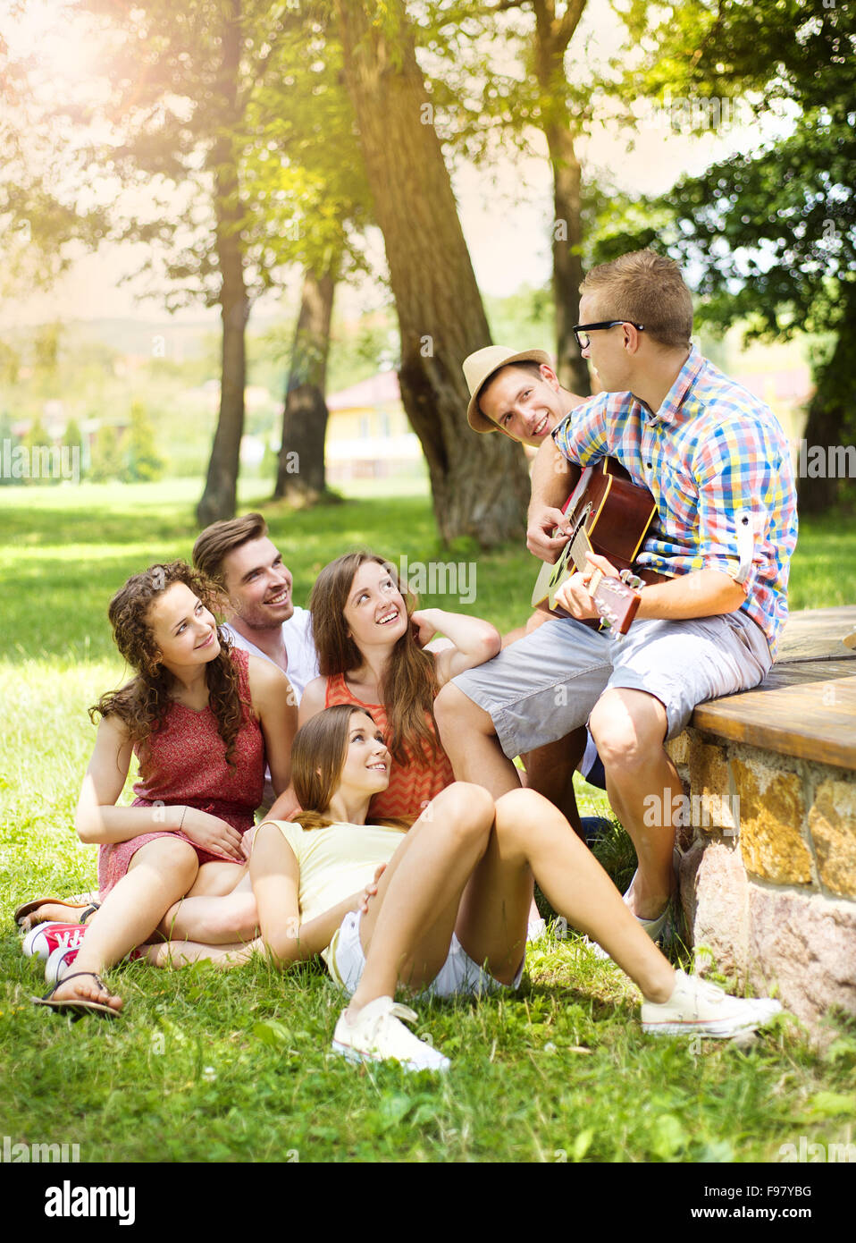 Group of happy friends with guitar having fun outdoor Stock Photo - Alamy
