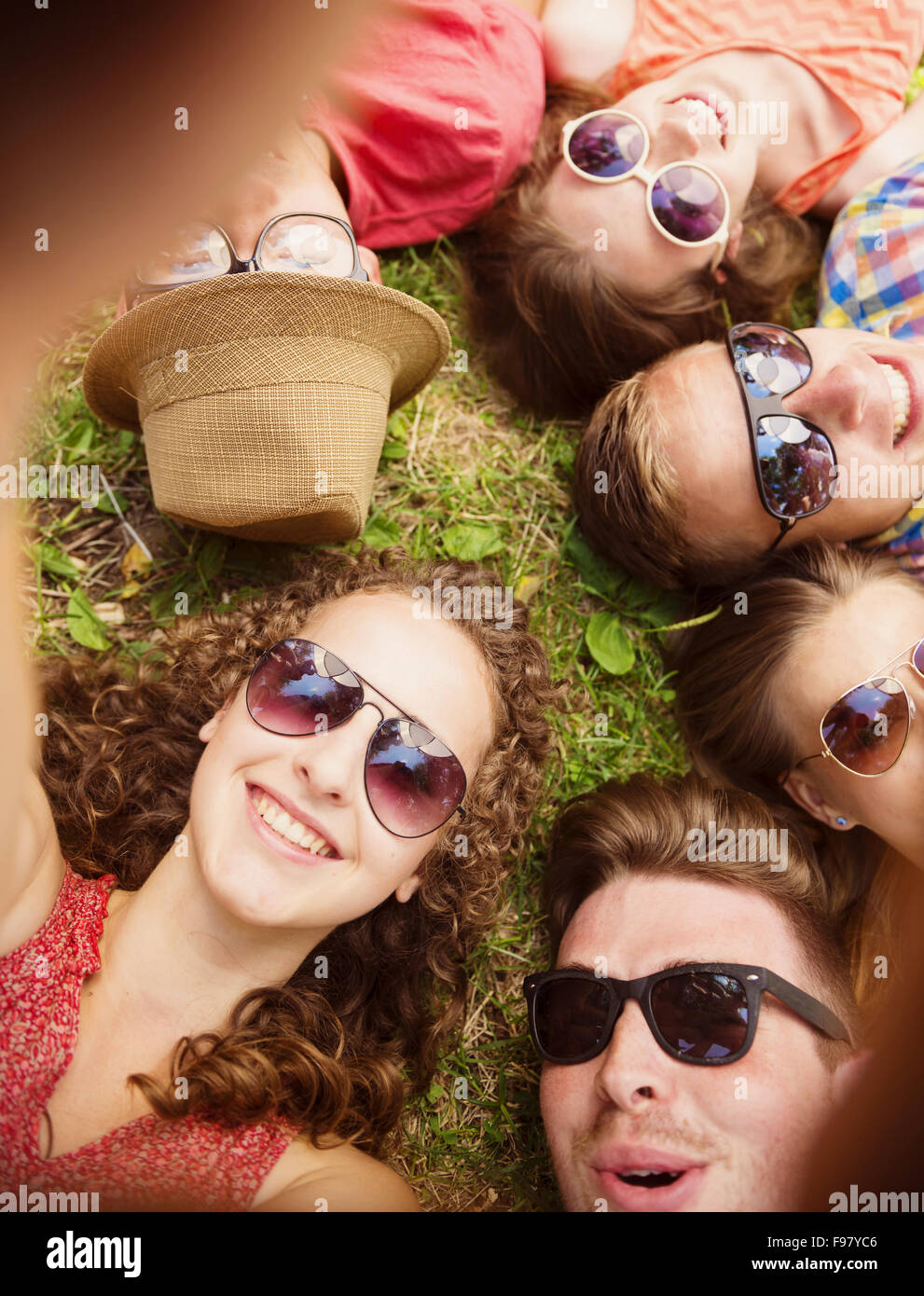 Group of young people having fun in park, lying on the grass Stock Photo