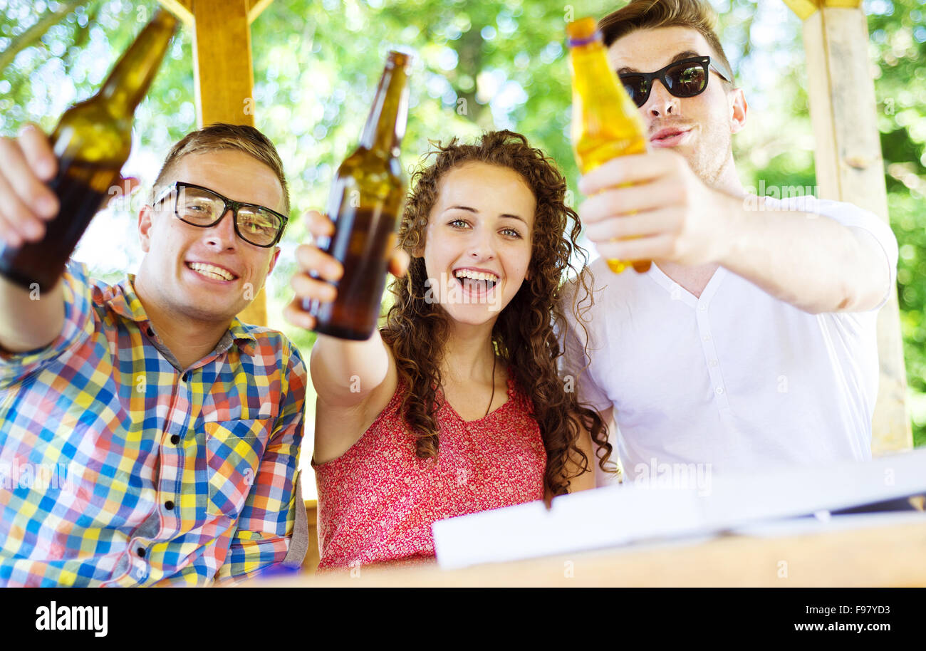 Group of happy friends drinking and having fun in pub garden Stock Photo