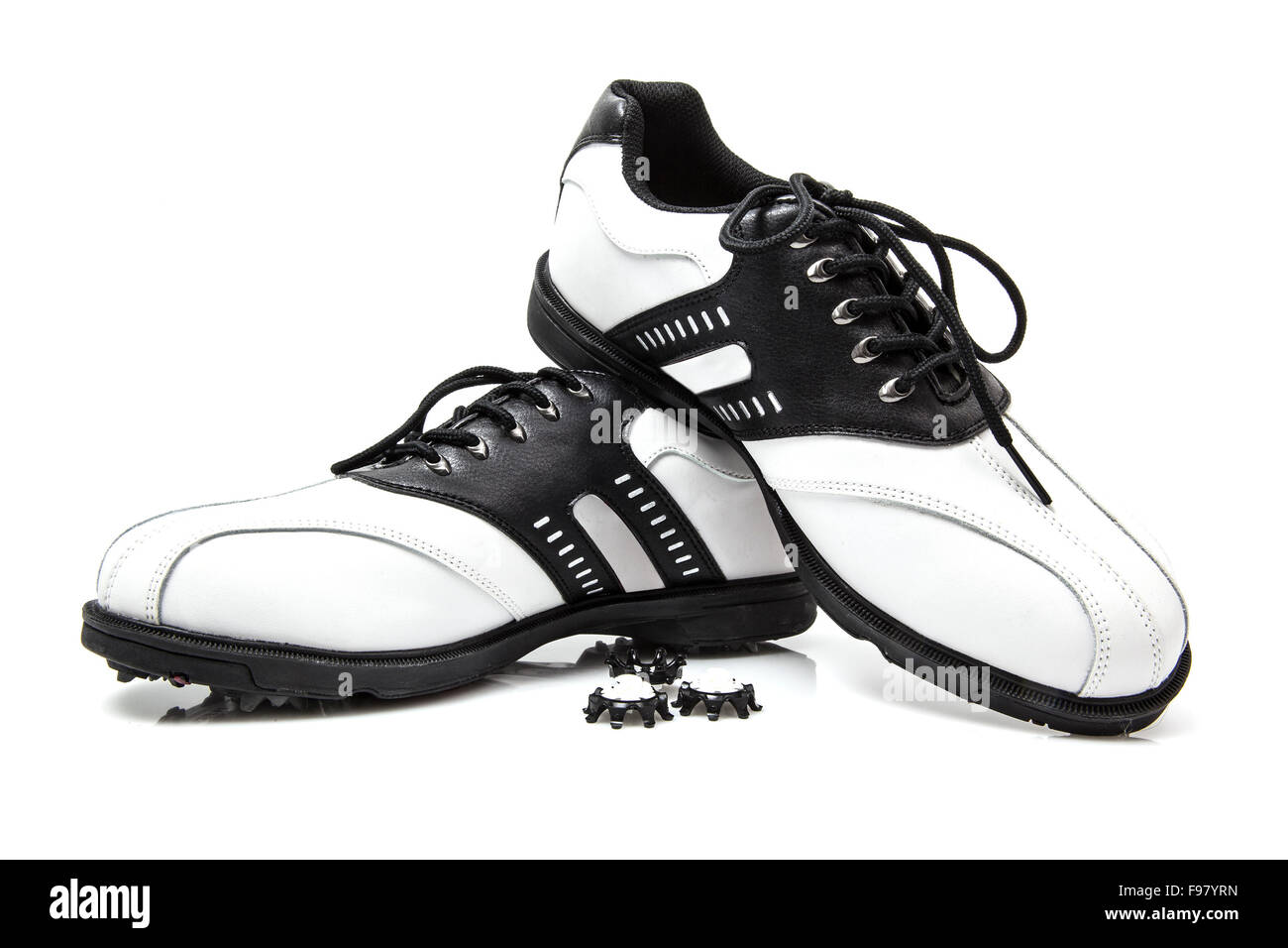 Golf shoes with spare spikes isolated on white Stock Photo