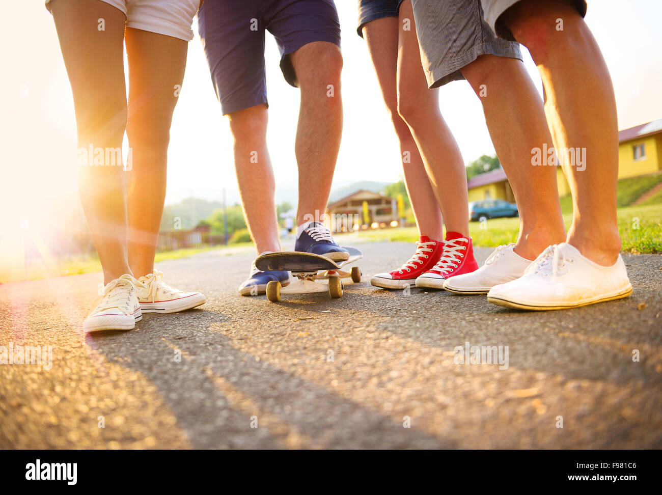 Closeup of legs and sneakers of young people on skateboard Stock Photo