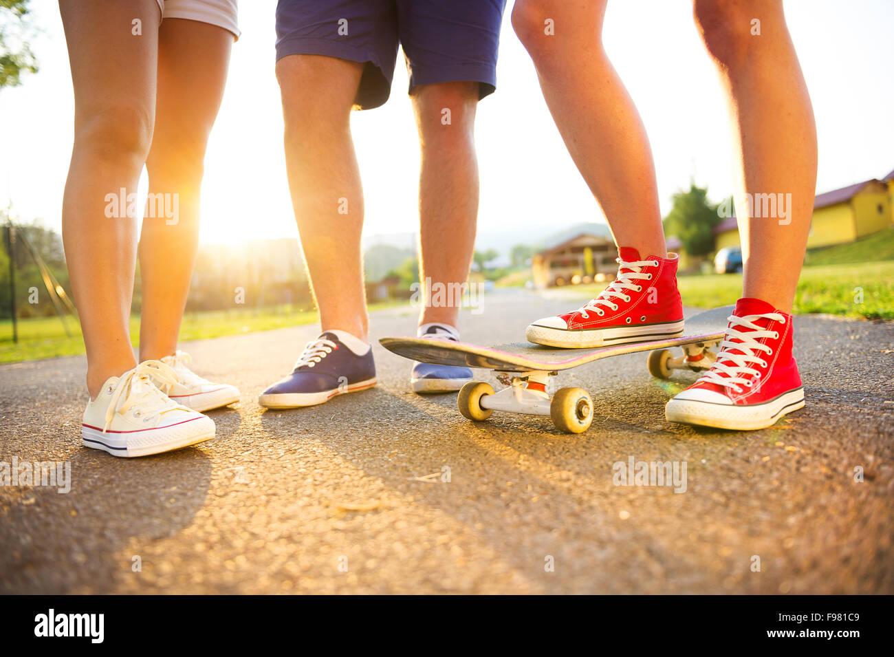 Closeup of legs and sneakers of young people on skateboard Stock Photo