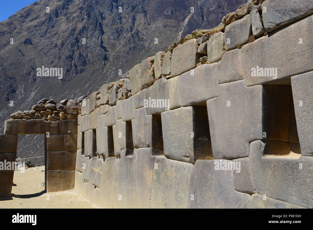 Wall with storage spaces and doorway at the Inca ruin of Ollantaytambo in the Sacred Valley of Peru. Stock Photo