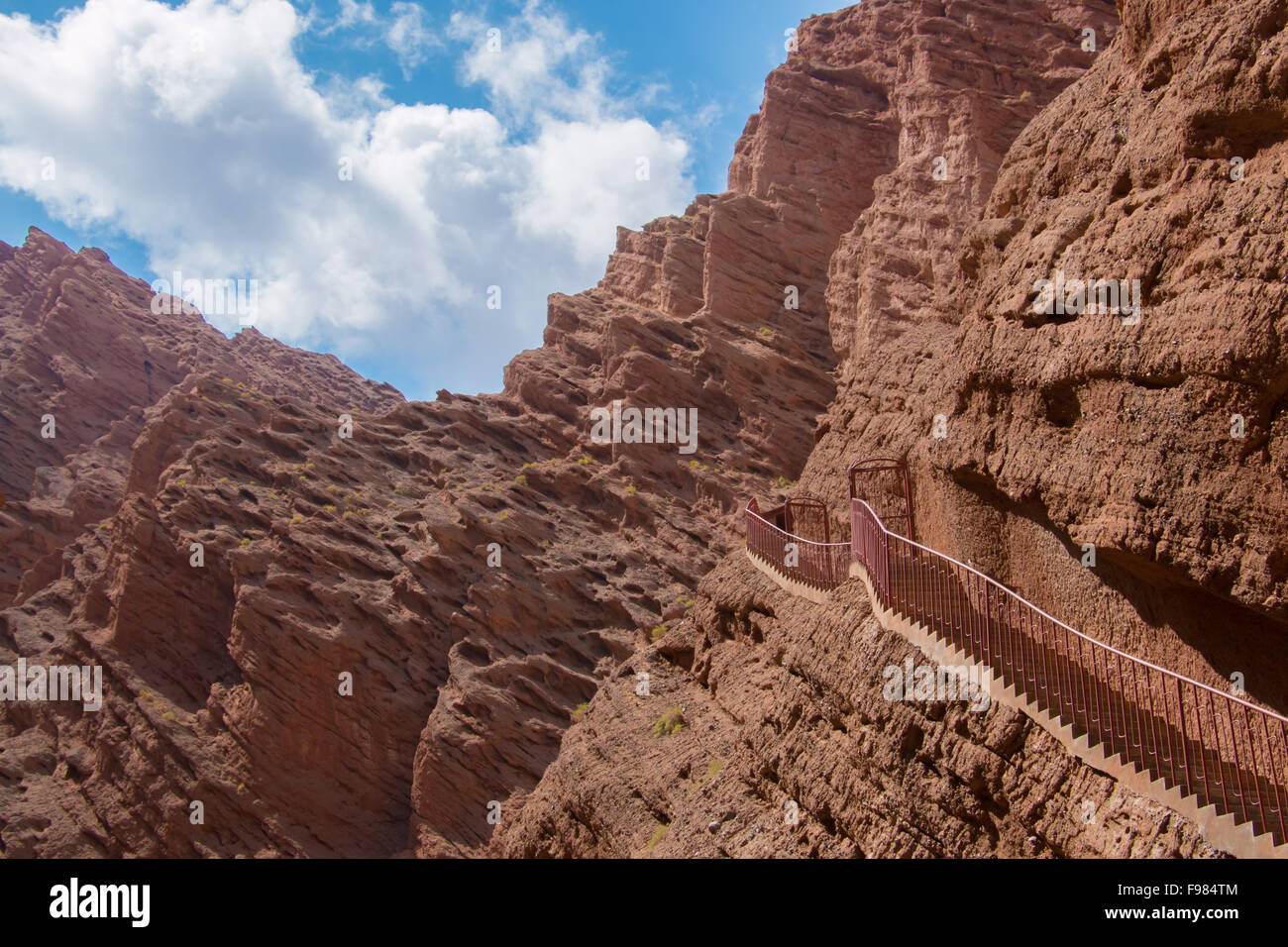 Stairs attached to red mountain leading to the sky in Xinjiang China Stock Photo