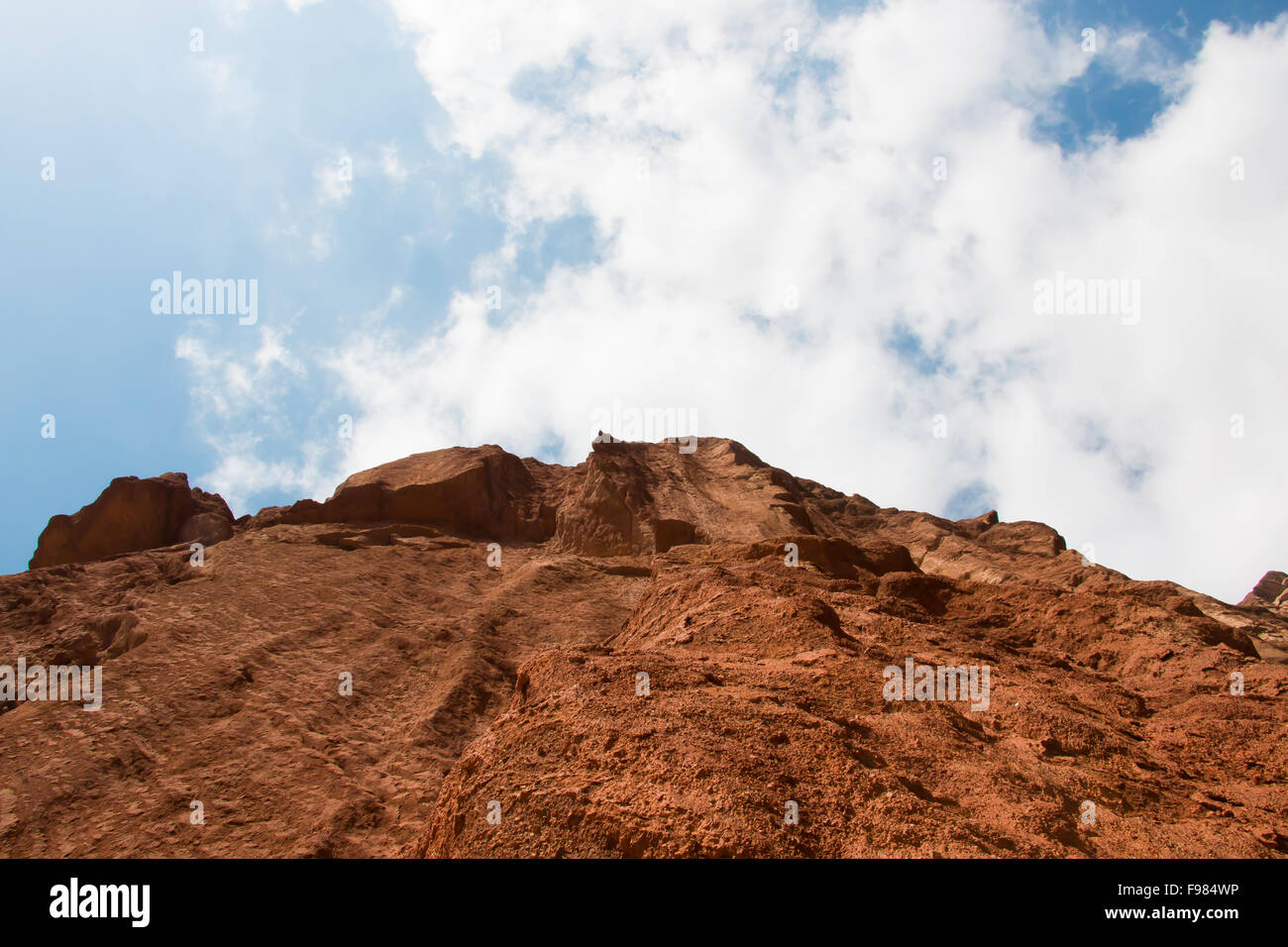 Steep mountain and cloudy blue sky in Xinjiang China Stock Photo