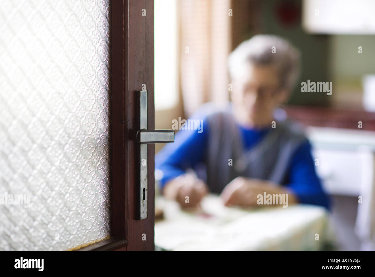 Old woman is sitting in her country style kitchen Stock Photo - Alamy
