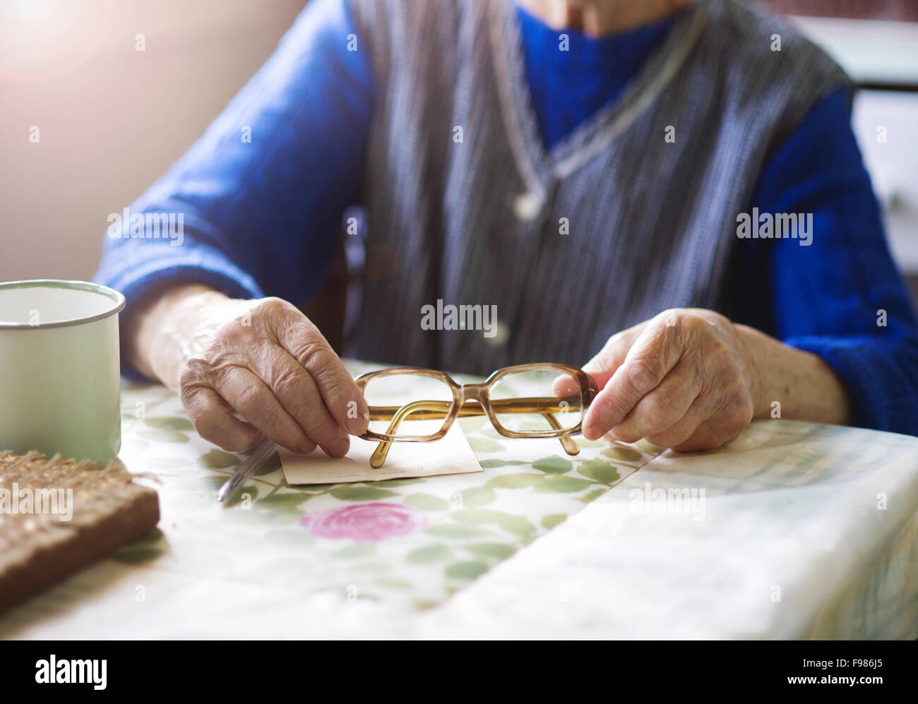 Old woman is sitting in her country style kitchen Stock Photo - Alamy