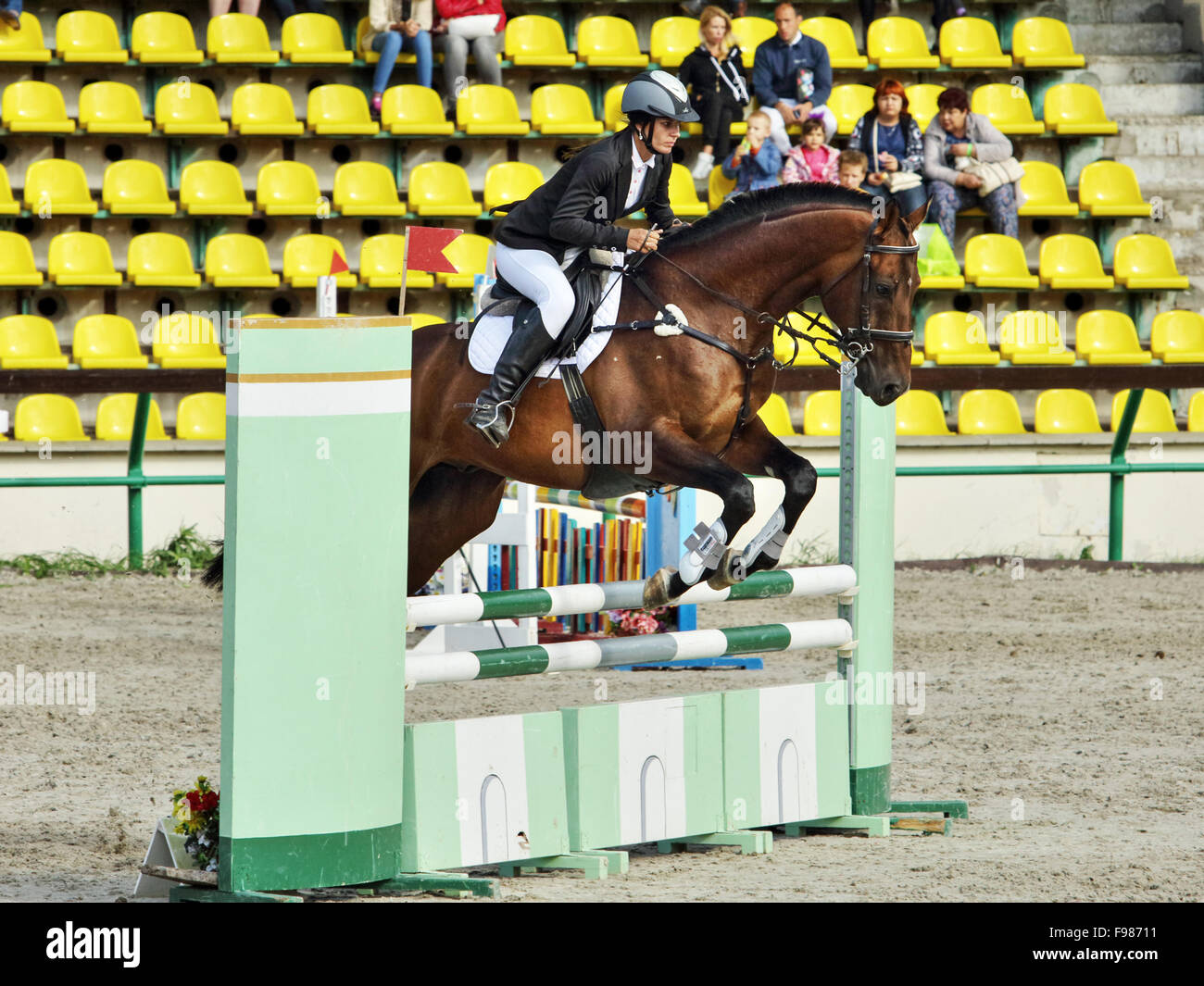 Women partecipating in a show jumping competition Stock Photo