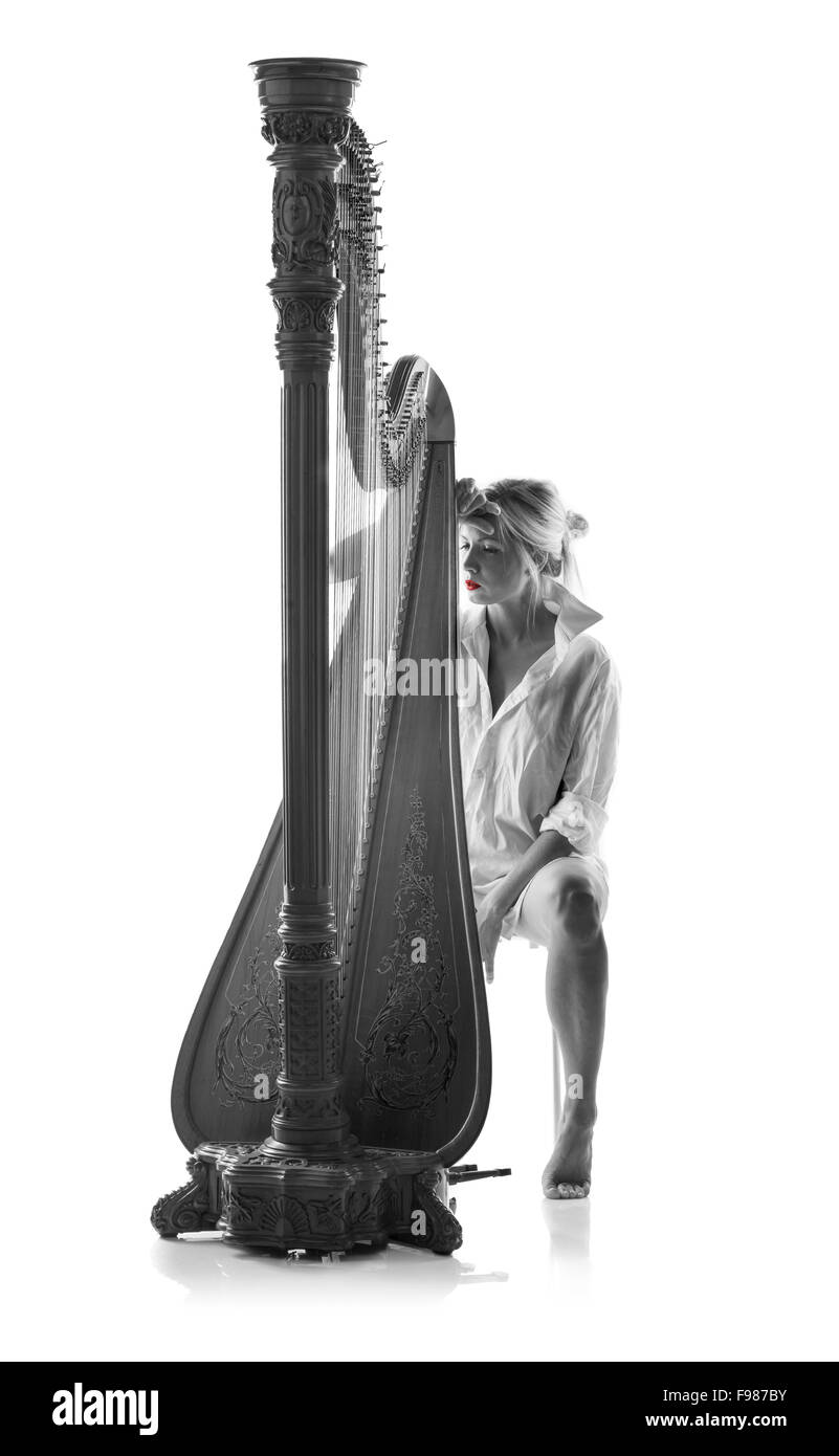 Black and white picture of woman in white shirt with harp, isolated on white background Stock Photo