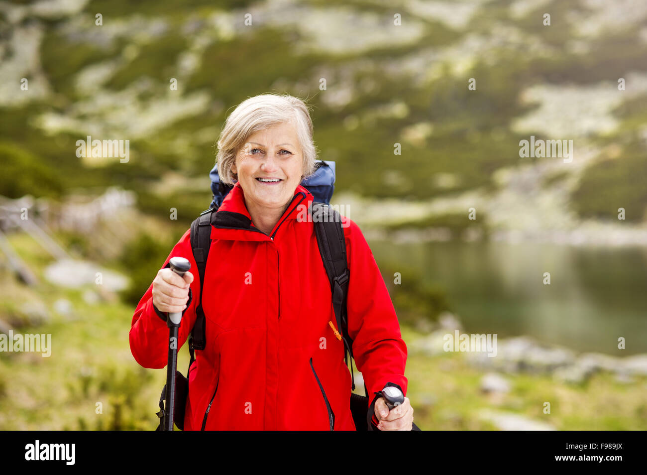 Senior tourist woman hiking at the beautiful mountains Stock Photo