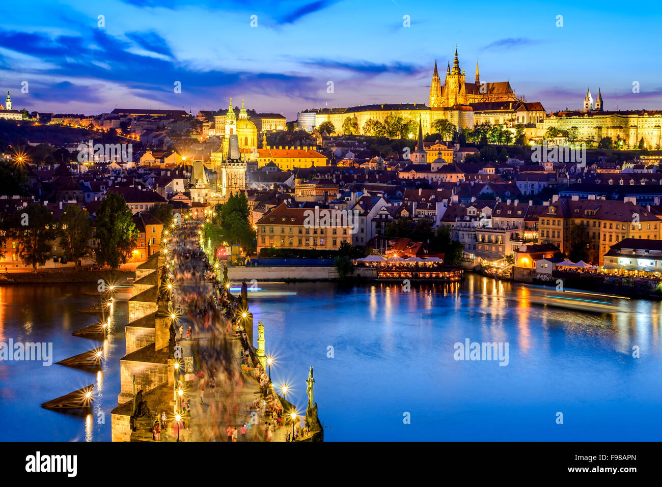 Prague, Czech Republic. Charles Bridge and Hradcany (Prague Castle) with St. Vitus Cathedral and St. George church evening dusk, Stock Photo