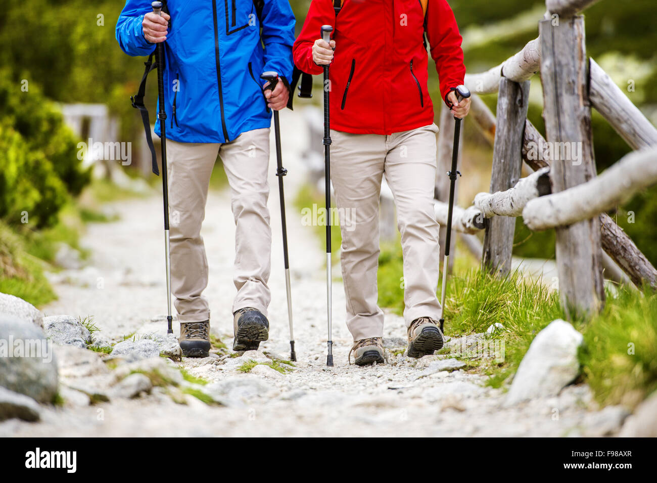Close-up of legs of senior couple hiking at the beautiful mountains Stock Photo