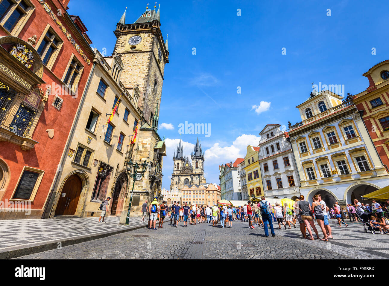 Tourists in Stare Mesto Square with Old Town Tower and Tyn Church, main attraction of Prague, Bohemia. Stock Photo