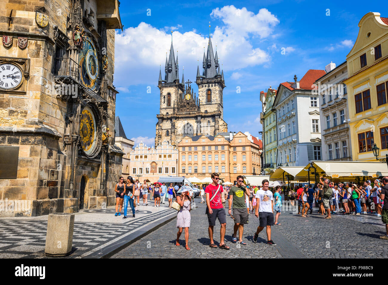 Tourists in Stare Mesto Square with Old Town Tower and Tyn Church, main attraction of Prague, Bohemia. Stock Photo