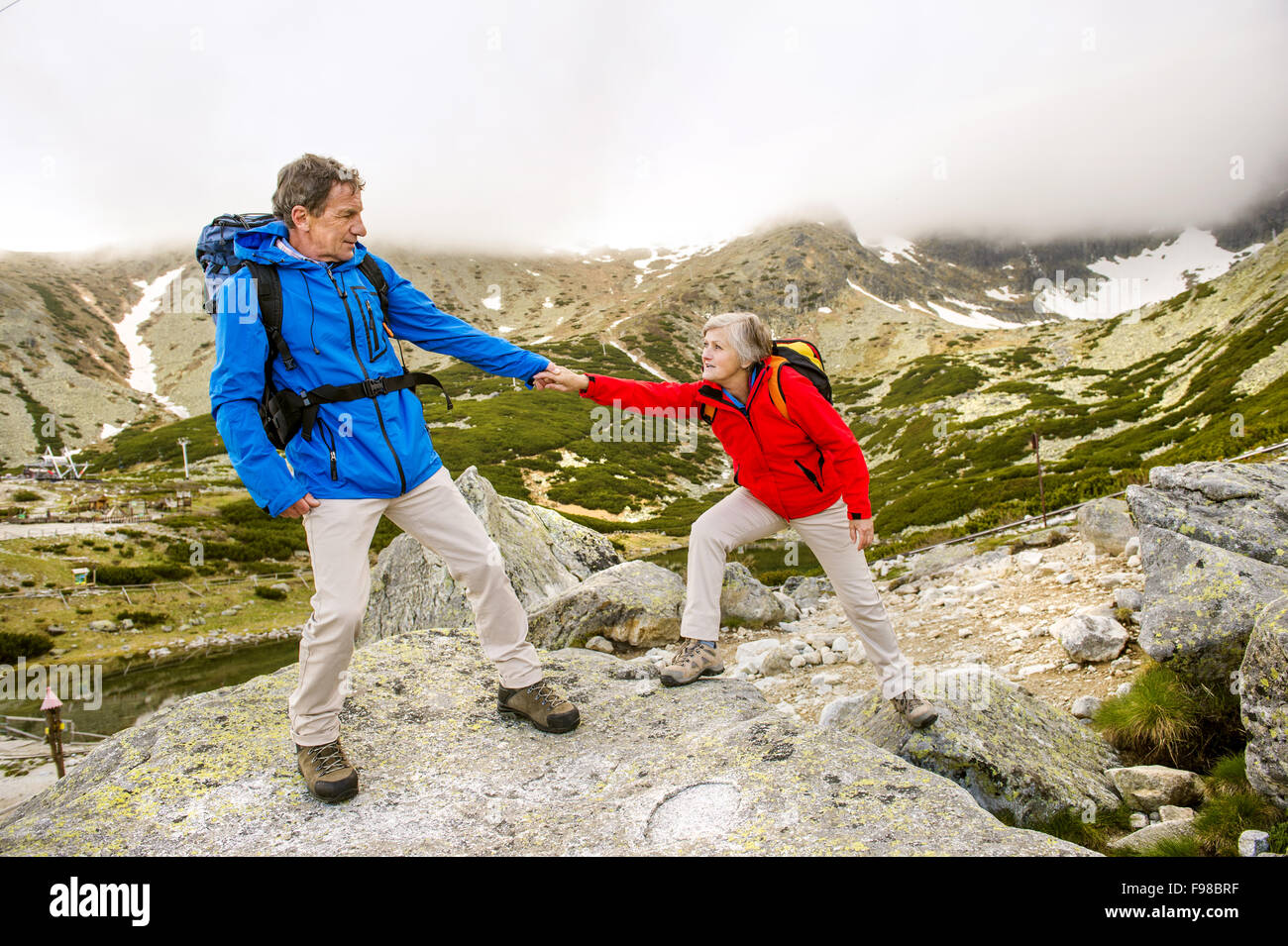 Happy man woman hiking mountains hi-res stock photography and images ...