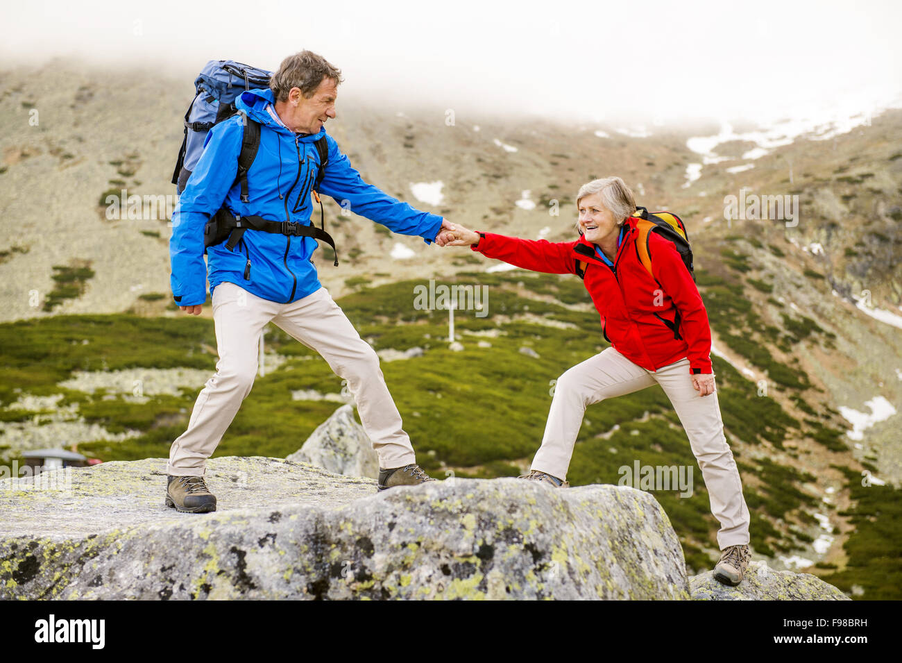 Happy man woman hiking mountains hi-res stock photography and images ...