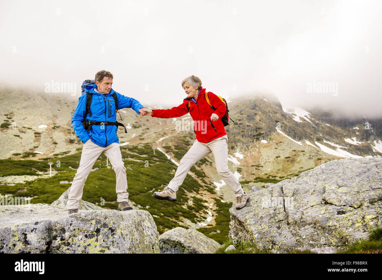 Happy man woman hiking mountains hi-res stock photography and images ...