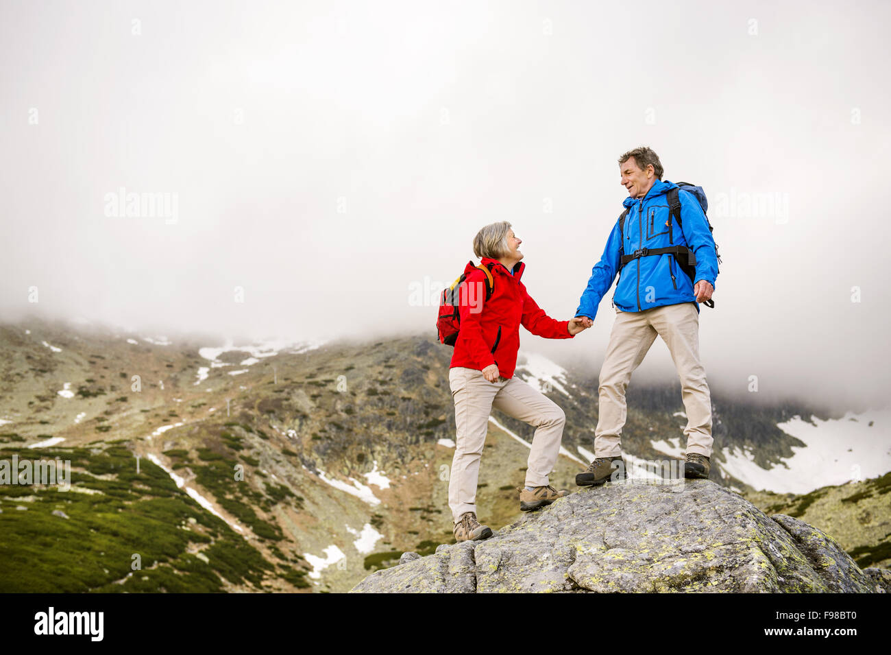 Happy man woman hiking mountains hi-res stock photography and images ...