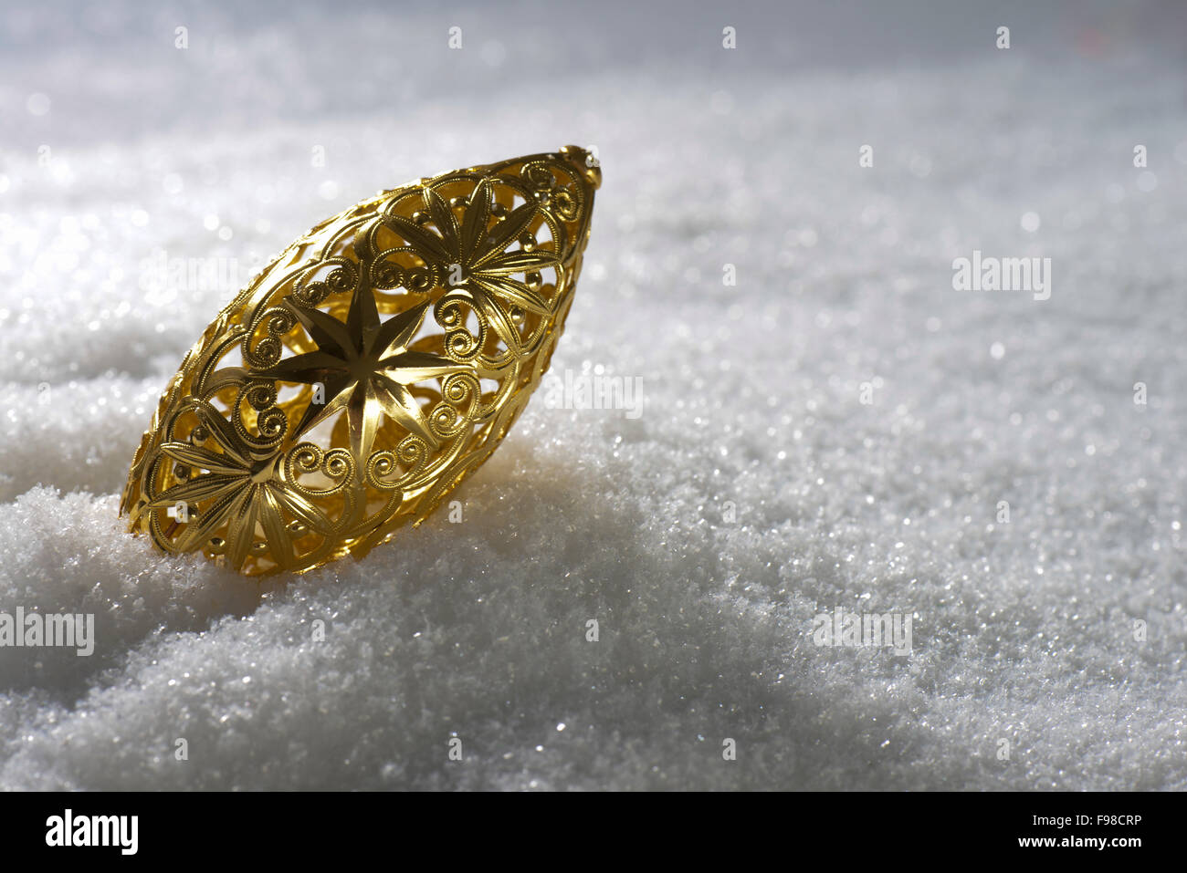 Christmas decoration in gold on snow Stock Photo